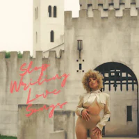 a woman is standing in front of a castle with the words stop writing love songs
