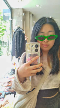 a woman is taking a selfie in front of a mirror
