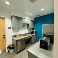 a small kitchen with a microwave and refrigerator