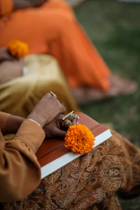a woman in an orange dress is holding a flower in her hand