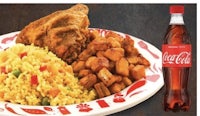 a plate with chicken, rice and coca cola