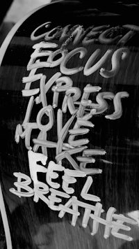 a black and white photo of a sign that says connect focus express love make feel breathe