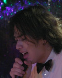 a man is singing into a microphone
