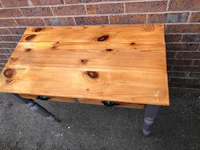 a small wooden table with two drawers