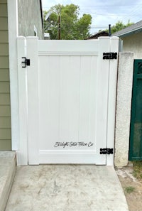 a white gate in front of a house