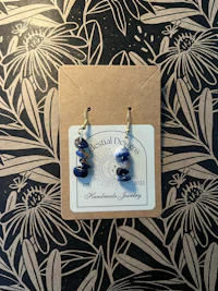 a pair of earrings with a blue stone on them