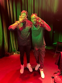 two men standing next to each other on a stage