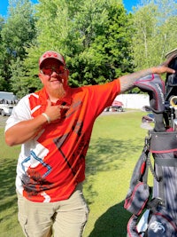 a man standing next to a golf bag