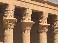egyptian pillars with statues on them