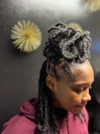 a woman with dreadlocks in her hair