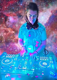 a man playing a dj set in front of a galaxy background
