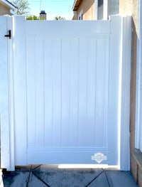 a white fence with a white gate