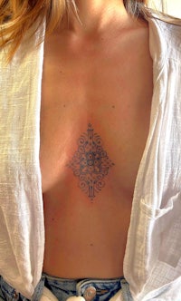 a woman with a tattoo on her chest