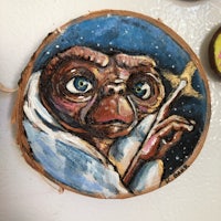a painting of a teddy bear on a piece of wood