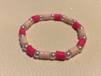 a pink and silver bracelet with pearls