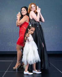 three girls and a little girl posing for a photo