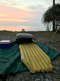 an inflatable raft on the beach at sunset