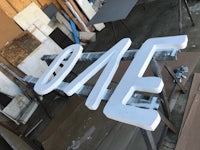 a white sign is being made in a workshop