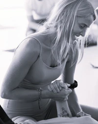 black and white photo of a woman in a yoga class