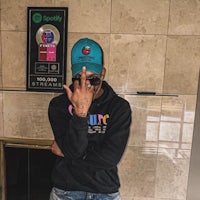a man in a blue hat is posing for a picture
