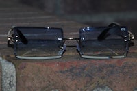 a pair of sunglasses sitting on a brick wall