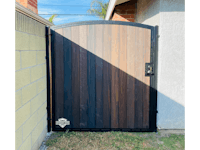 a wooden gate in front of a house