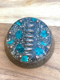 a turquoise and copper button on a wooden table