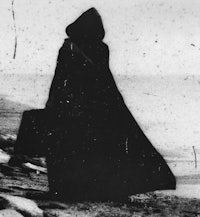 a silhouette of a woman wearing a cloak and carrying a suitcase