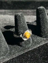 a ring with a yellow stone on it