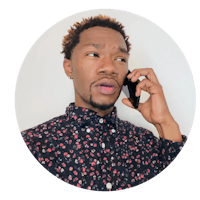 a man talking on a cell phone in a floral shirt