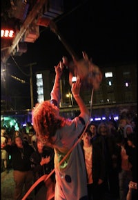 a woman in a costume is performing in front of a crowd