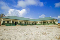 a white building on a sand beach