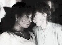a black and white photo of two women looking at each other