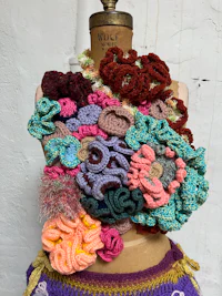 a mannequin with a bunch of crocheted flowers