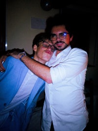 a man is hugging a man