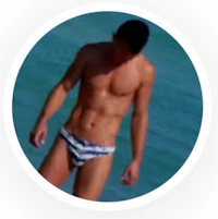 a man in a blue and white bikini standing in the water