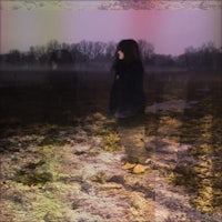 a woman standing in a field at night