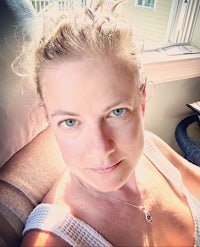 a woman sitting in a chair looking at the camera