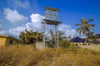 a metal tower in the middle of a field