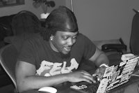 a man sitting at a desk using a laptop