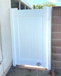 a white gate in front of a house