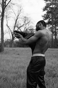 a black and white photo of a man in a field