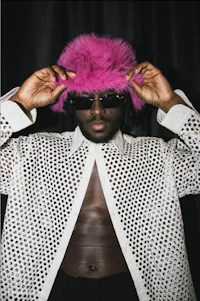 a man wearing a pink hat and white shirt