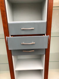 a blue and gray cabinet with drawers in it