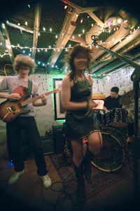 a group of people playing music in a dark room