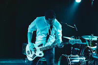 a man playing a bass on stage