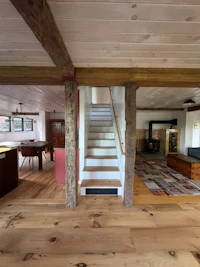 a living room with wood floors and a staircase