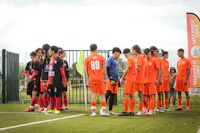 a group of soccer players standing on a field