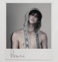 a polaroid photo of a young man in a hoodie