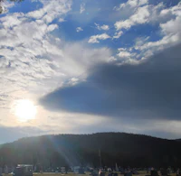 a cloudy sky over a cemetery